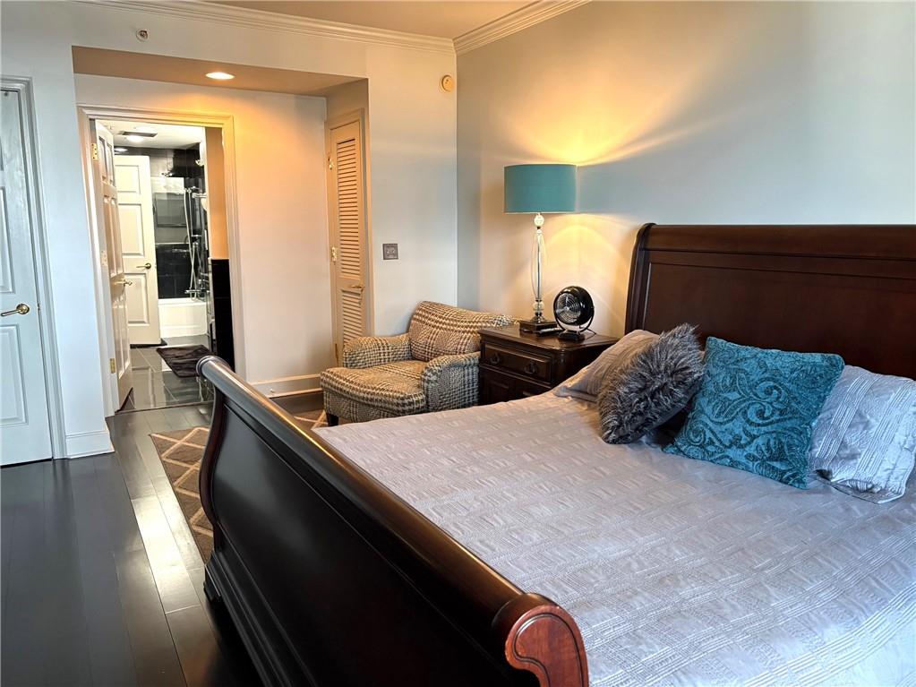 75 14th Street Northeast, Unit 3340 Atlanta, GA 30309 - Photo 12 of 24 a large bedroom with bed and wooden floor