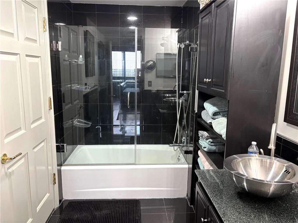 75 14th Street Northeast, Unit 3340 Atlanta, GA 30309 - Photo 15 of 24 a bathroom with a tub and a shower