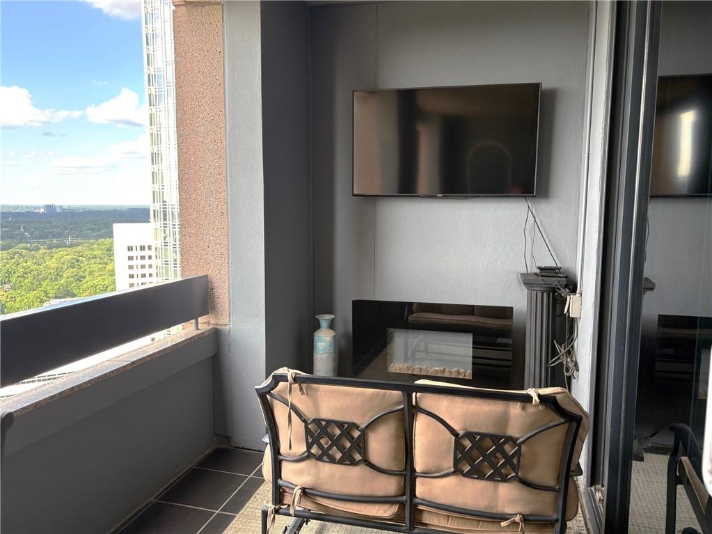 75 14th Street Northeast, Unit 3340 Atlanta, GA 30309 - Photo 19 of 24 a dining room with a fireplace and a floor to ceiling window