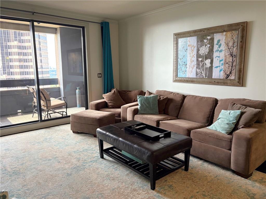 75 14th Street Northeast, Unit 3340 Atlanta, GA 30309 - Photo 8 of 24 a living room with furniture and a large window