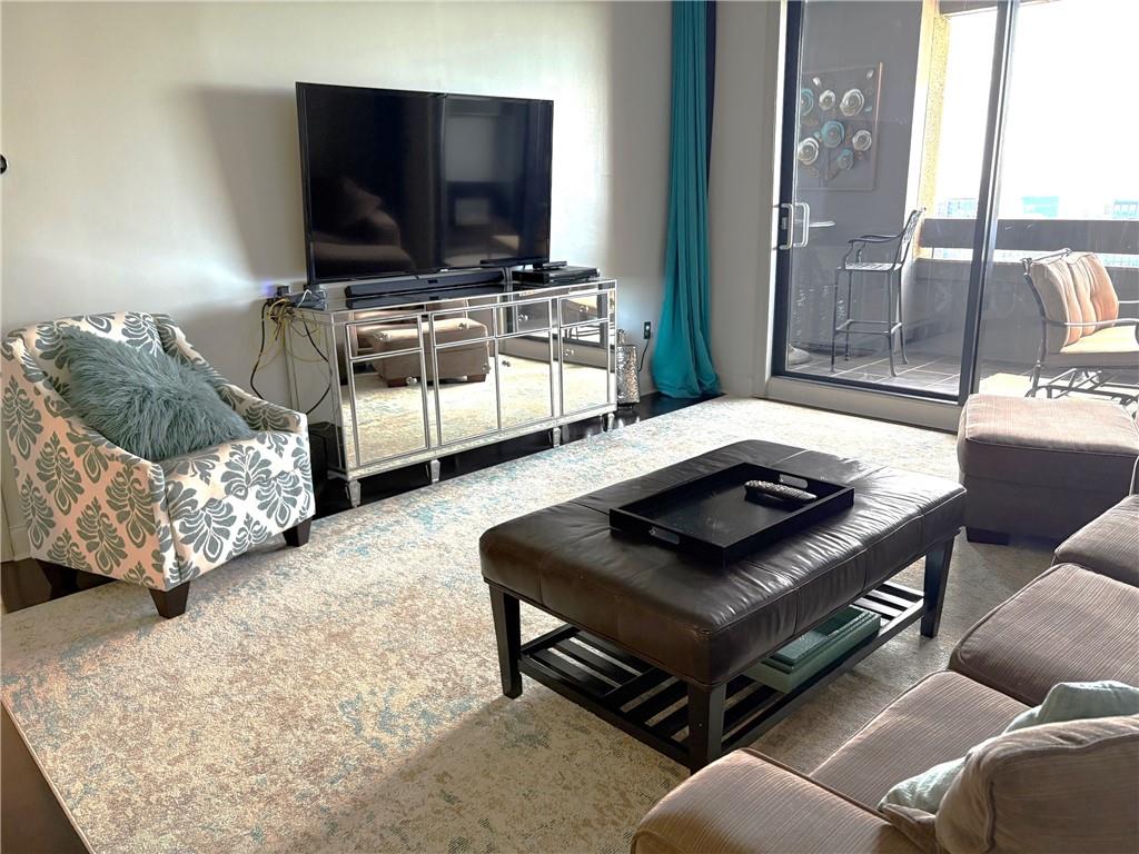 75 14th Street Northeast, Unit 3340 Atlanta, GA 30309 - Photo 9 of 24 a living room with furniture and a flat screen tv