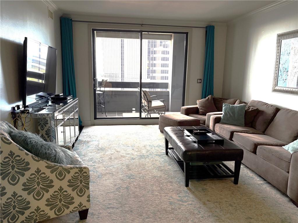 75 14th Street Northeast, Unit 3340 Atlanta, GA 30309 - Photo 10 of 24 a living room with furniture and a flat screen tv