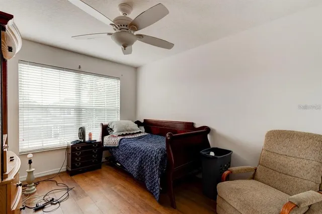 a living room with furniture ceiling fan and a window