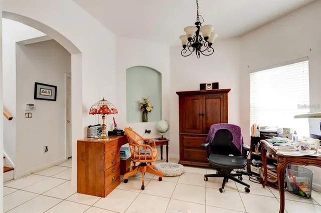 a view of a workspace with furniture and a window