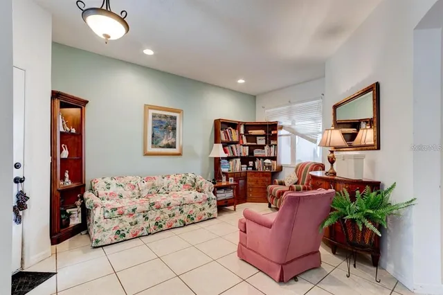 a living room with furniture flowerpot and window