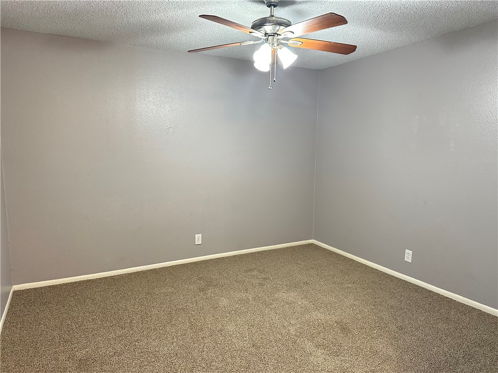 1041 Comal Street Corpus Christi, TX 78407 - Photo 2 of 12 an empty room with windows and fan