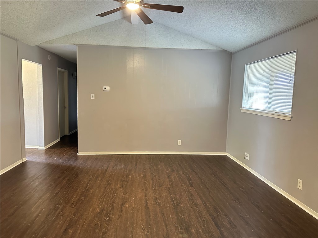 1041 Comal Street Corpus Christi, TX 78407 - Photo 3 of 12 an empty room with wooden floor chandelier fan and windows