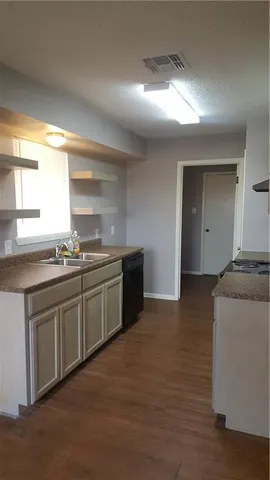 a kitchen with stainless steel appliances granite countertop a sink and cabinets