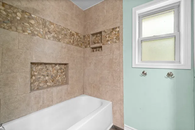a bathroom with a bathtub and a shower