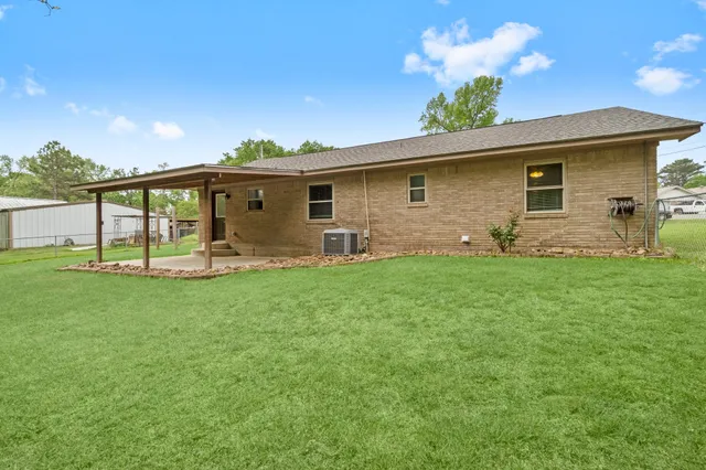 a front view of house with yard and outdoor seating