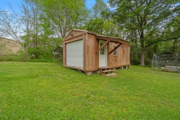 a backyard of a house with table and chairs