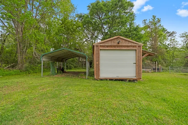 a backyard of a house with table and chairs