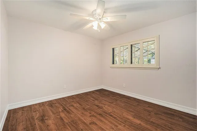 a bathroom with a granite countertop sink a toilet a mirror and shower