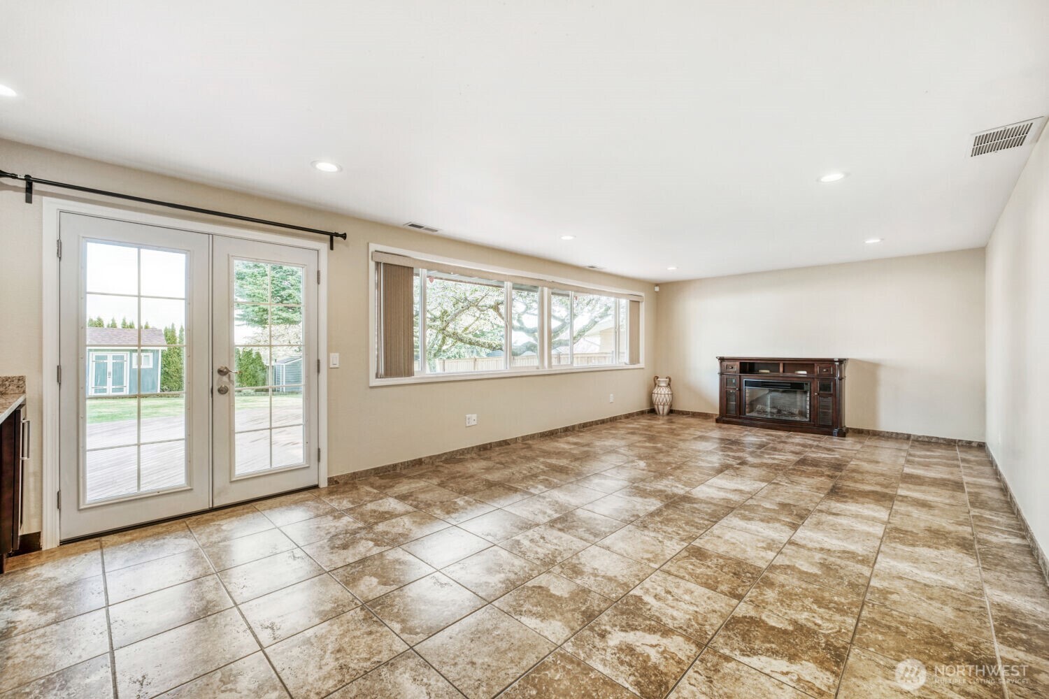 3618 South 243rd Street Kent, WA 98032 - Photo 6 of 37 a view of an empty room with a fireplace and a window