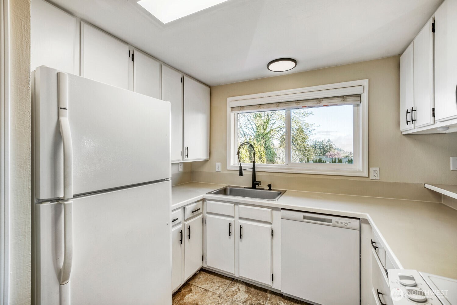3618 South 243rd Street Kent, WA 98032 - Photo 9 of 37 a kitchen with stainless steel appliances granite countertop a refrigerator sink and stove