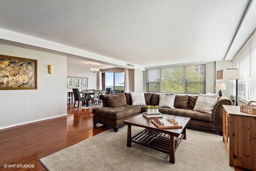 1616 Sheridan Road, Unit 5H Wilmette, IL 60091 - Photo 6 of 26 a living room with furniture a table and a large window