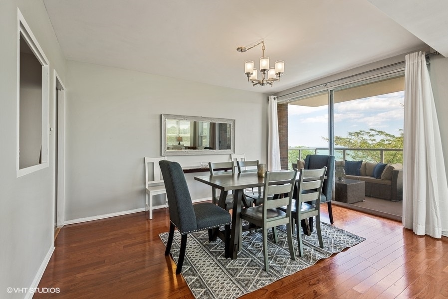 1616 Sheridan Road, Unit 5H Wilmette, IL 60091 - Photo 10 of 26 a view of a dining room with furniture window and wooden floor