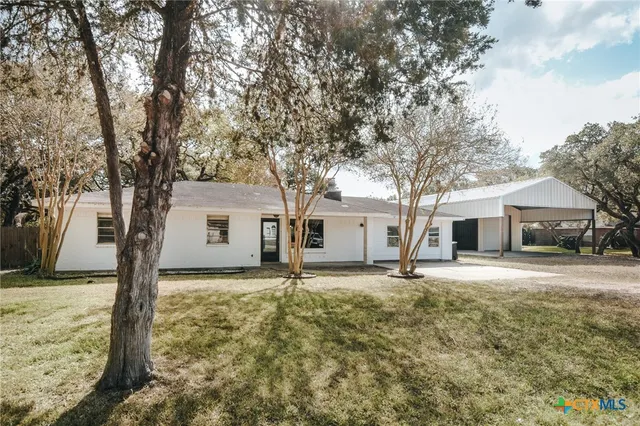 a house with trees in the background