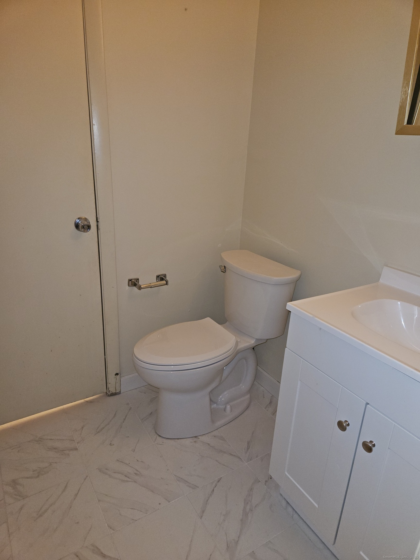 38 Sutton Place, Unit 38 Bloomfield, CT 06002 - Photo 16 of 17 a white toilet sitting next to a shower