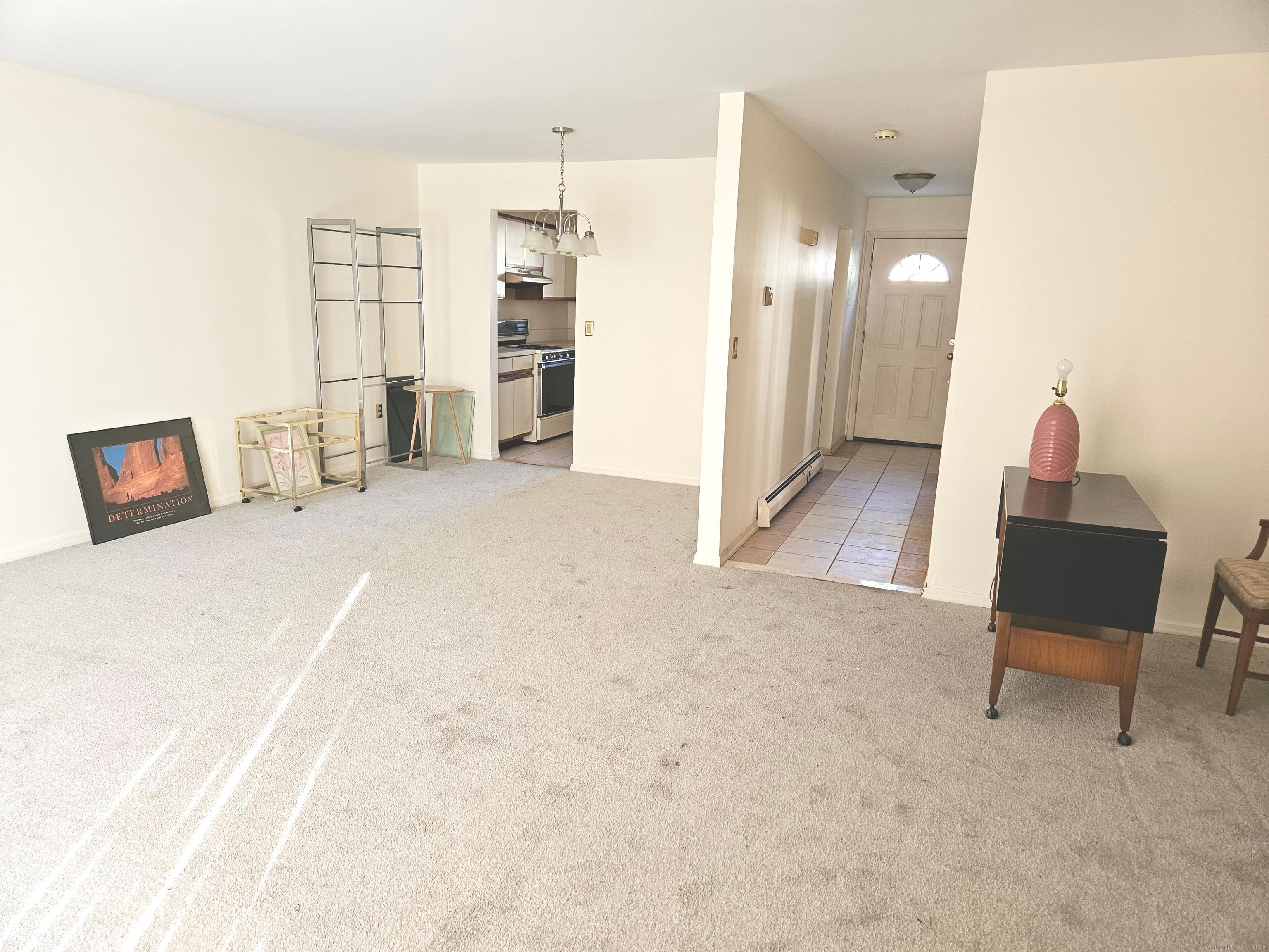 38 Sutton Place, Unit 38 Bloomfield, CT 06002 - Photo 5 of 17 a spacious bedroom with a bed and chair