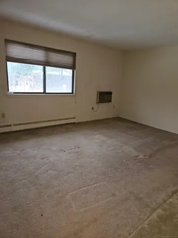 an empty room with a empty space and windows