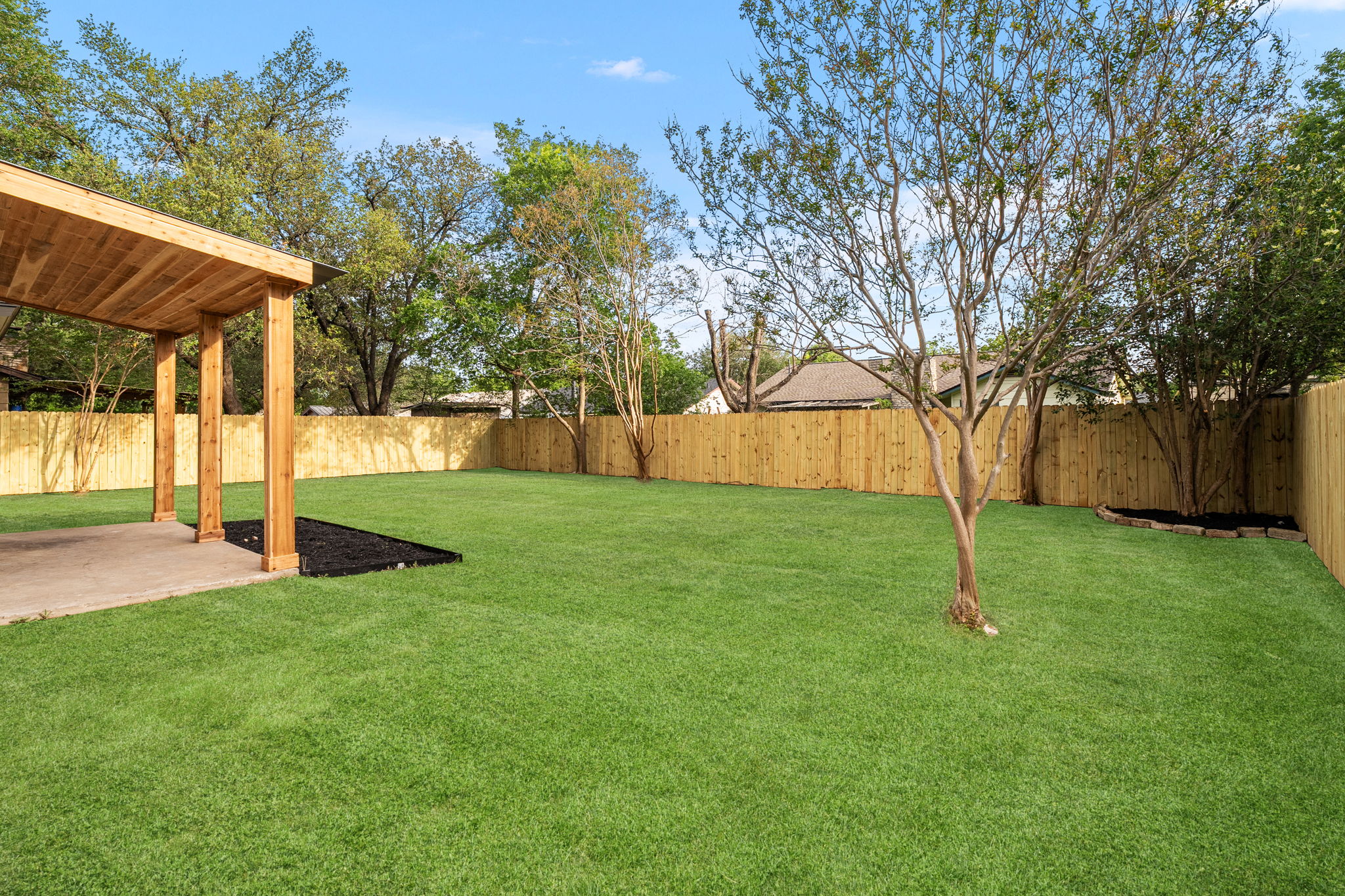 2107 Cindy Lane Austin, TX 78727 - Photo 29 of 33 Spacious backyard featuring a covered patio, and new wood fencing