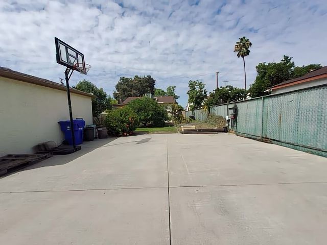 a view of a street with potted plants