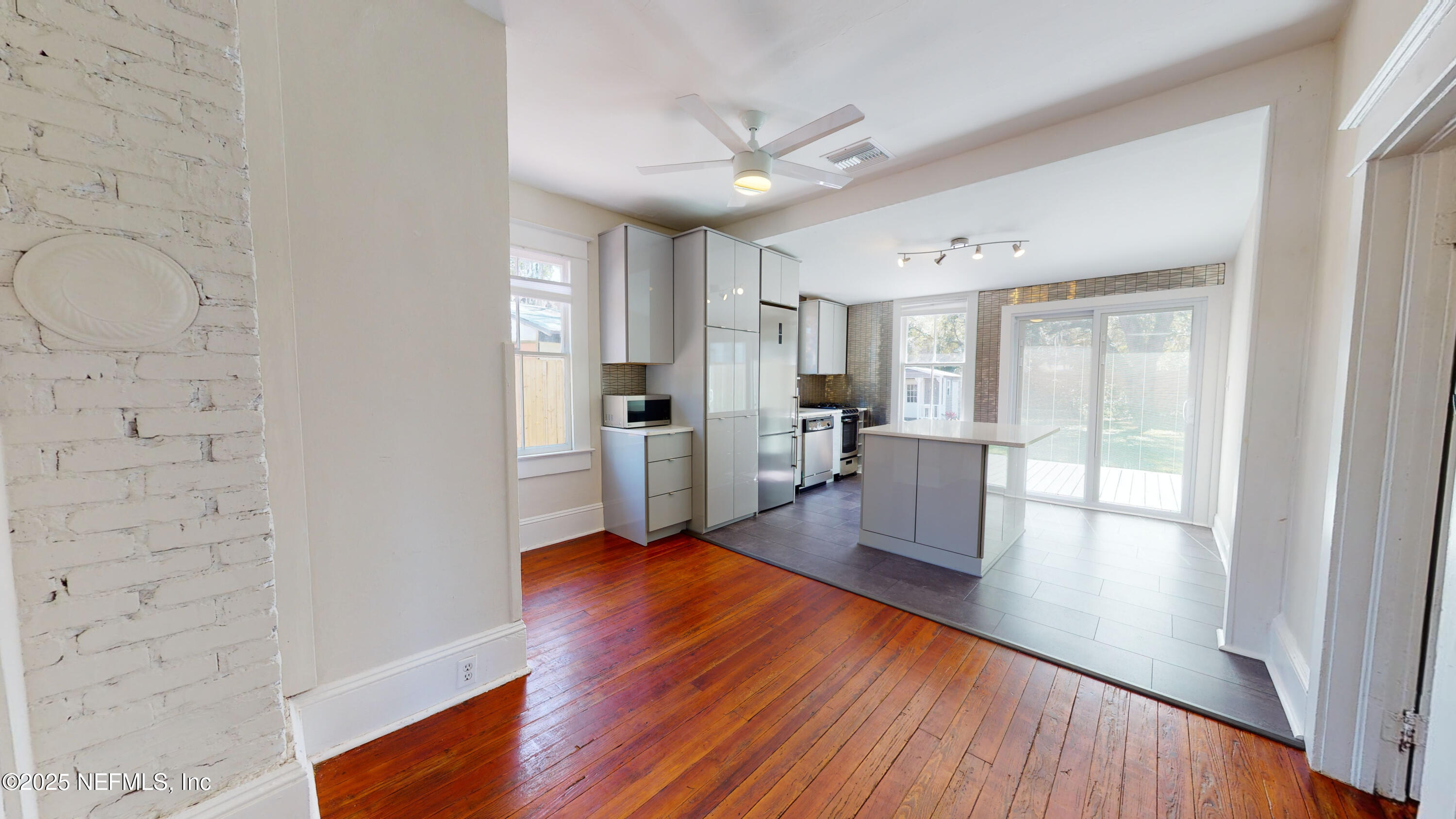 11 Hildreth Drive St. Augustine, FL 32084 - Photo 12 of 25 a living room with stainless steel appliances kitchen island wooden floor and large windows