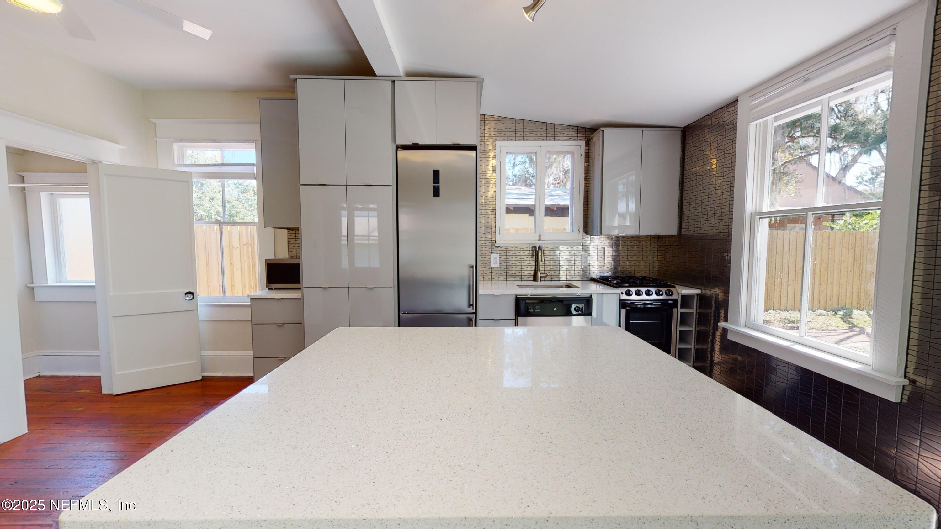 11 Hildreth Drive St. Augustine, FL 32084 - Photo 13 of 25 a large white kitchen with sink a refrigerator and wooden floor
