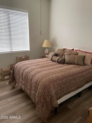 a bedroom with a bed and a window