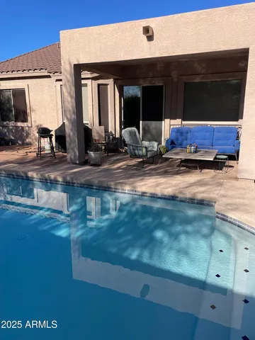 a view of living room kitchen with stainless steel appliances granite countertop cabinets and a fireplace