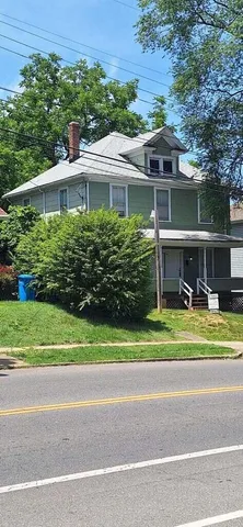 a front view of house with a garden