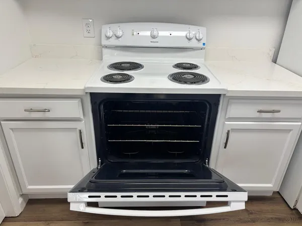 a stove top oven sitting inside of a kitchen