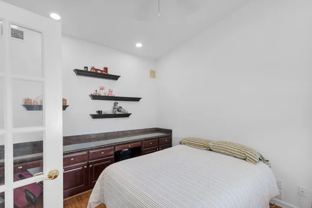 a bedroom with a bed and a chandelier