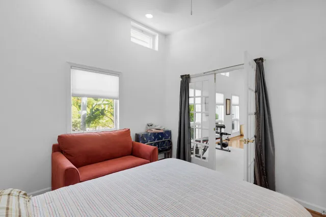 a bedroom with a bed couch and a window