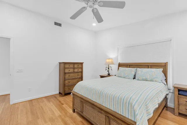a bedroom with a bed and a ceiling fan