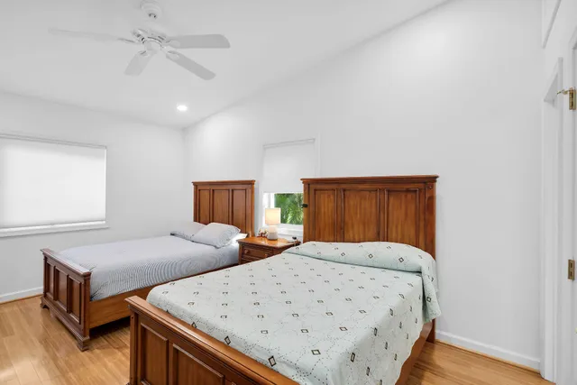 a bedroom with two beds and a dresser