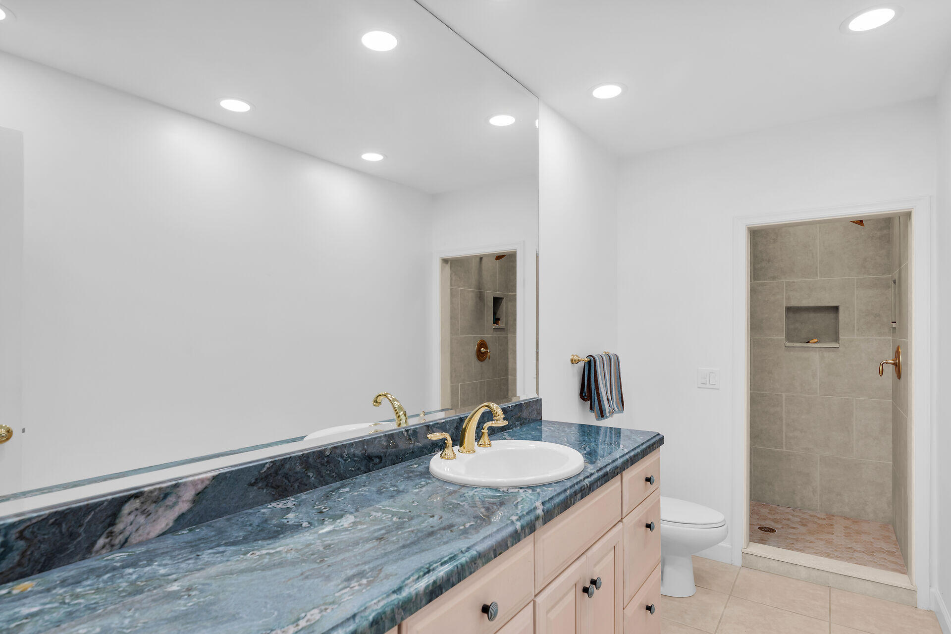 7501 Gulfstream Boulevard Marathon, FL 33050 - Photo 31 of 48 a bathroom with a granite countertop sink and a mirror
