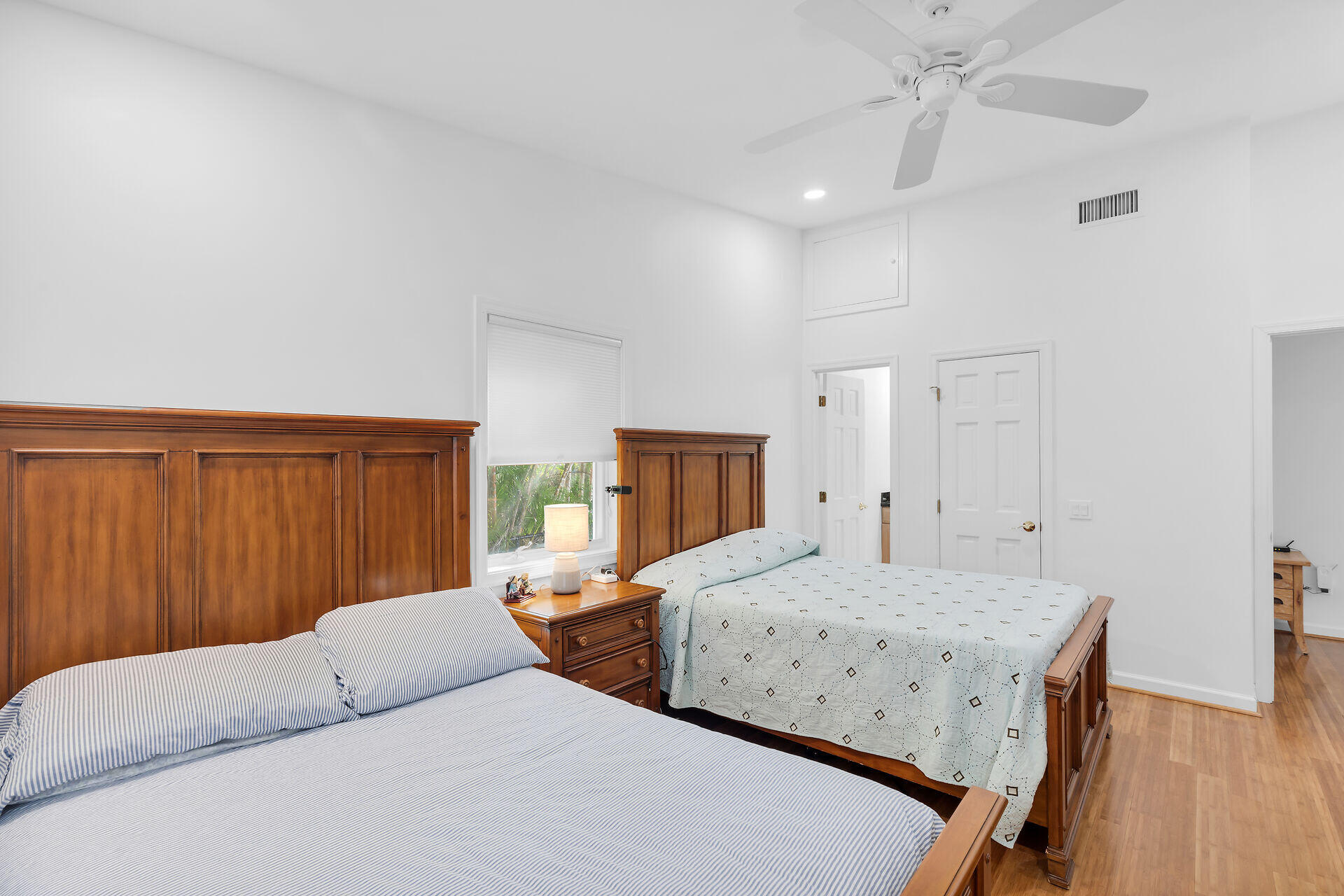 7501 Gulfstream Boulevard Marathon, FL 33050 - Photo 7 of 48 a bedroom with a large bed and wooden floor