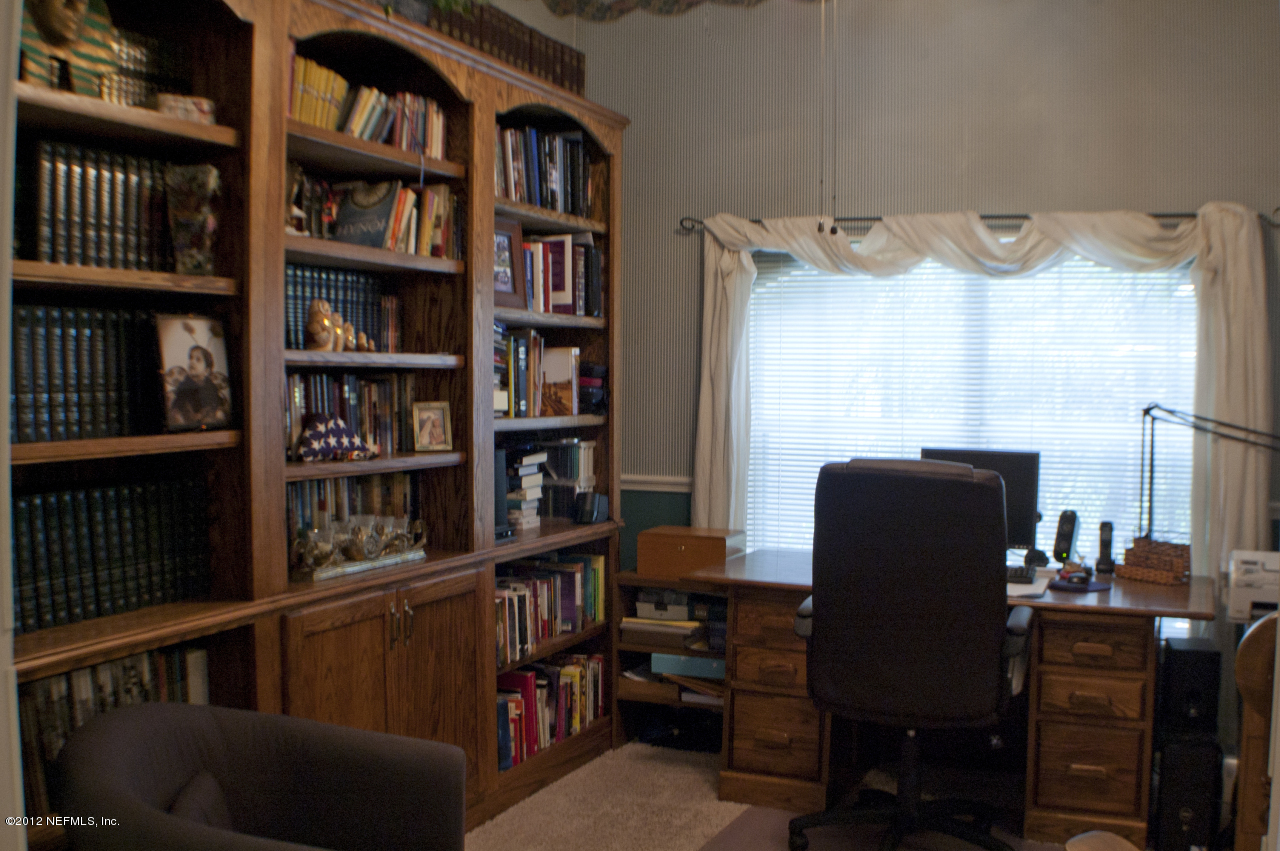 690 Roberts Road St. Johns, FL 32259 - Photo 16 of 32 a view of a workspace with bookshelf