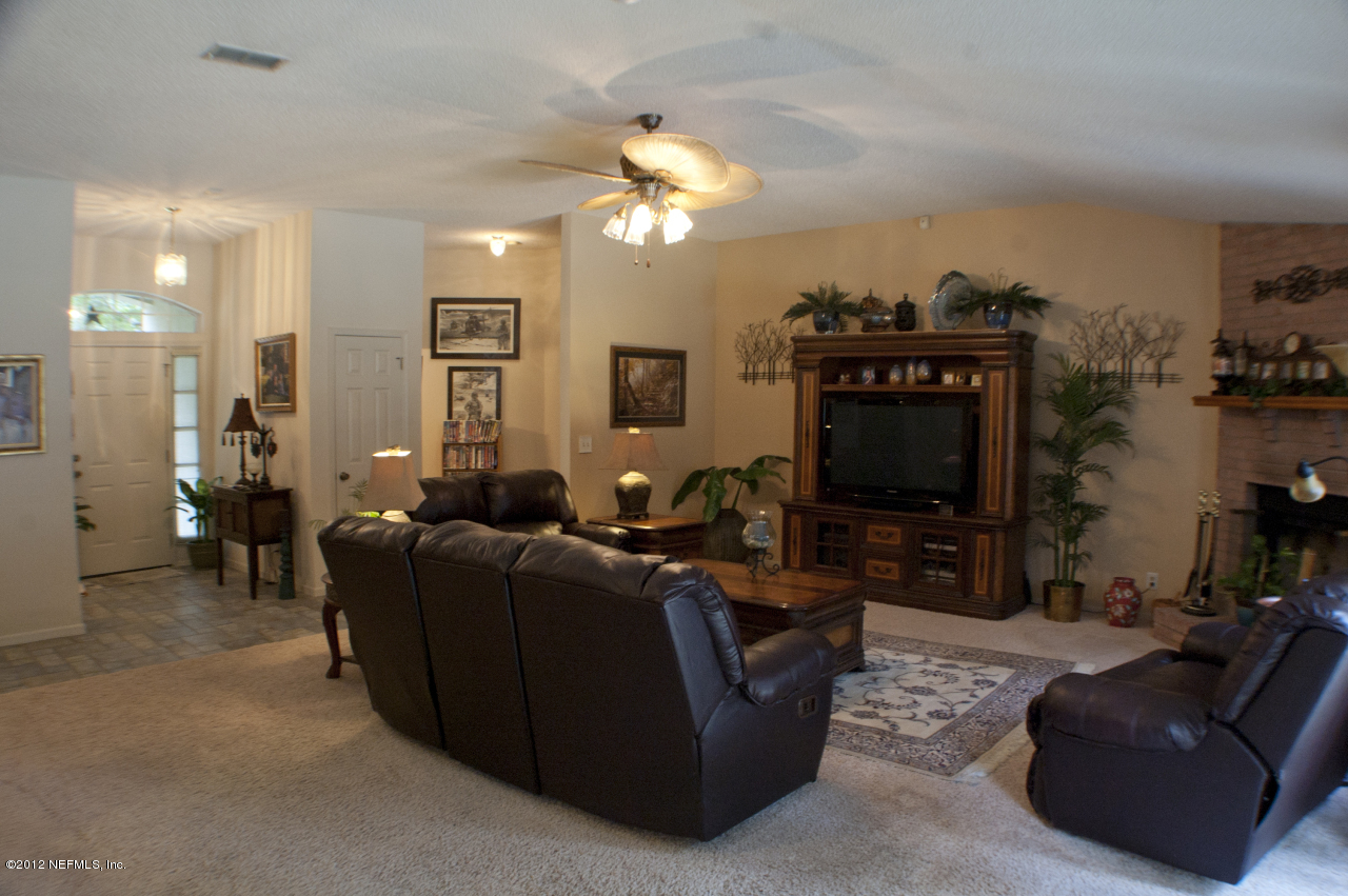690 Roberts Road St. Johns, FL 32259 - Photo 7 of 32 a living room with furniture and a flat screen tv