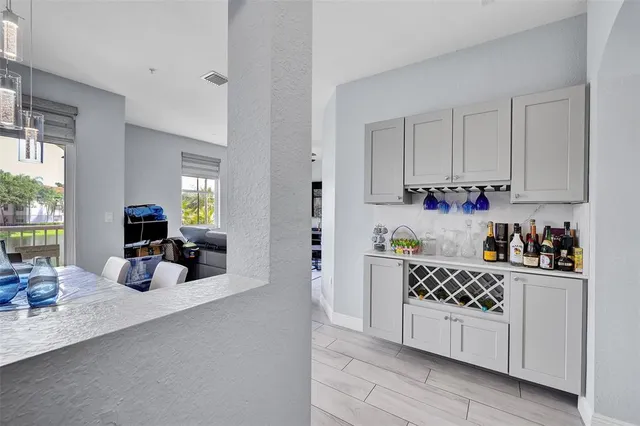 a kitchen with sink cabinets and living room view