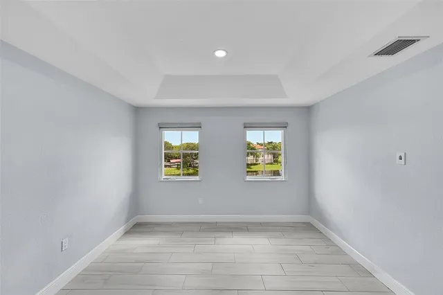 a view of room with window and wooden floor
