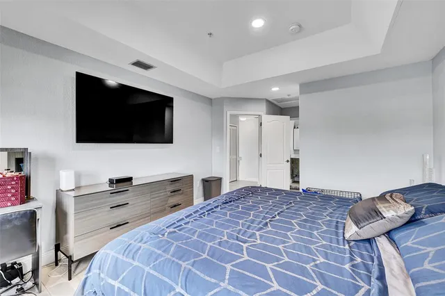 a bedroom with a bed and a flat screen tv