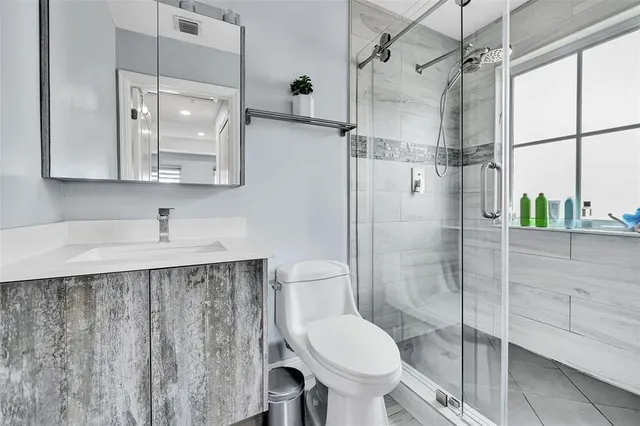 a bathroom with a sink toilet and shower