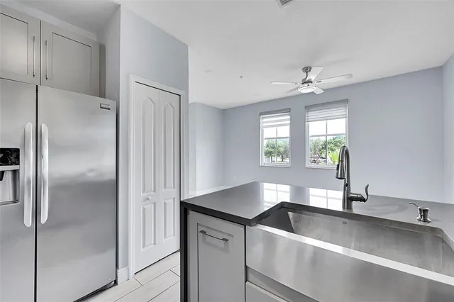 a modern kitchen with stainless steel appliances granite countertop a refrigerator and a sink