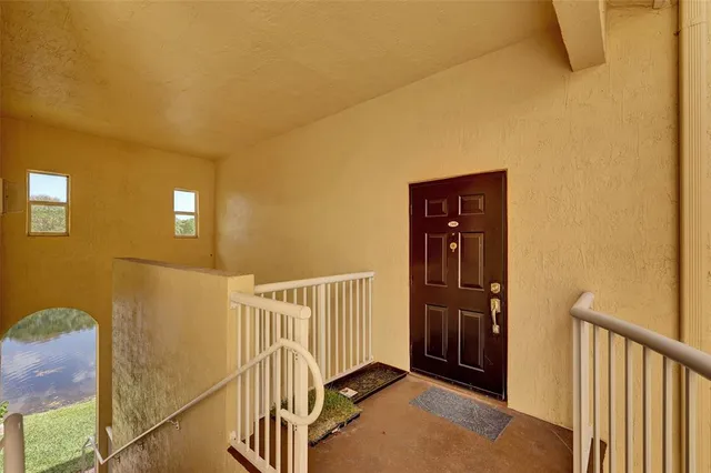 a view of staircase with railing and a window
