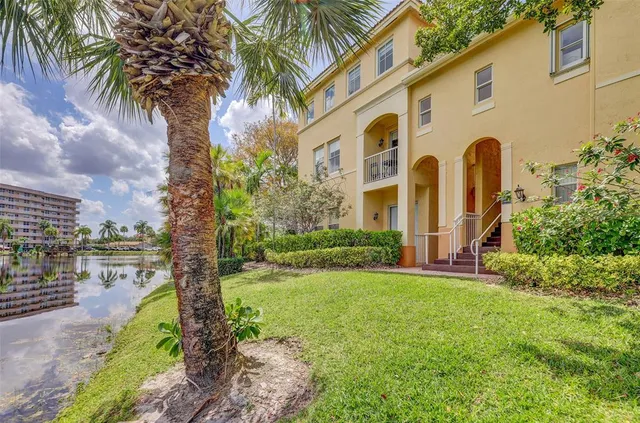 a front view of a house with yard and green space