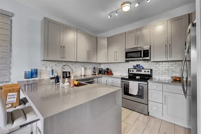 a kitchen with a sink a stove and cabinets