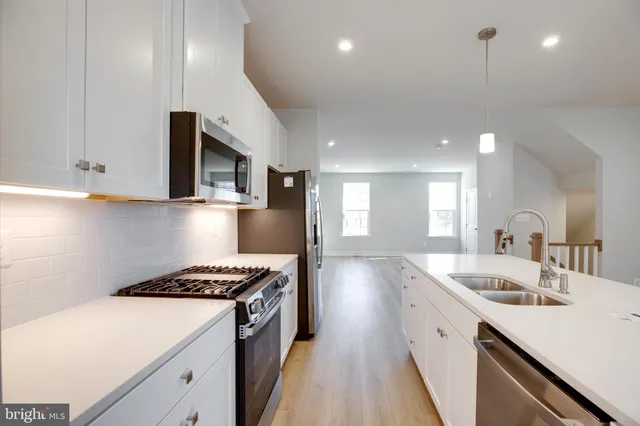 a kitchen that has a sink and a stove in it
